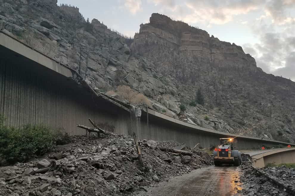 Equipment works to clear mud and debris from a mudslide on Interstate-70 through Glenwood Canyon, Colorado (Colorado Department of Transportation via AP)