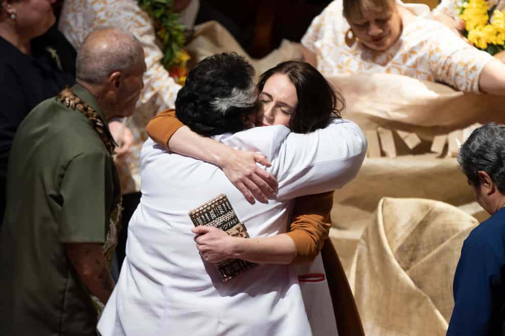 Jacinda Ardern is hugged during a ceremony in Auckland (Brett Phibbs/New Zealand Herald via AP)
