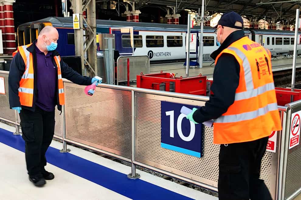 Handrails being cleaned at Liverpool Lime Street station (Network Rail/PA)