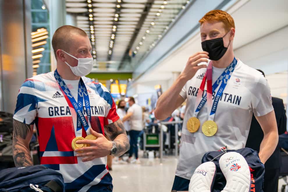 British swimmers Adam Peaty (left) and Tom Dean arrive back at London Heathrow Airport (Aaron Chown/PA)