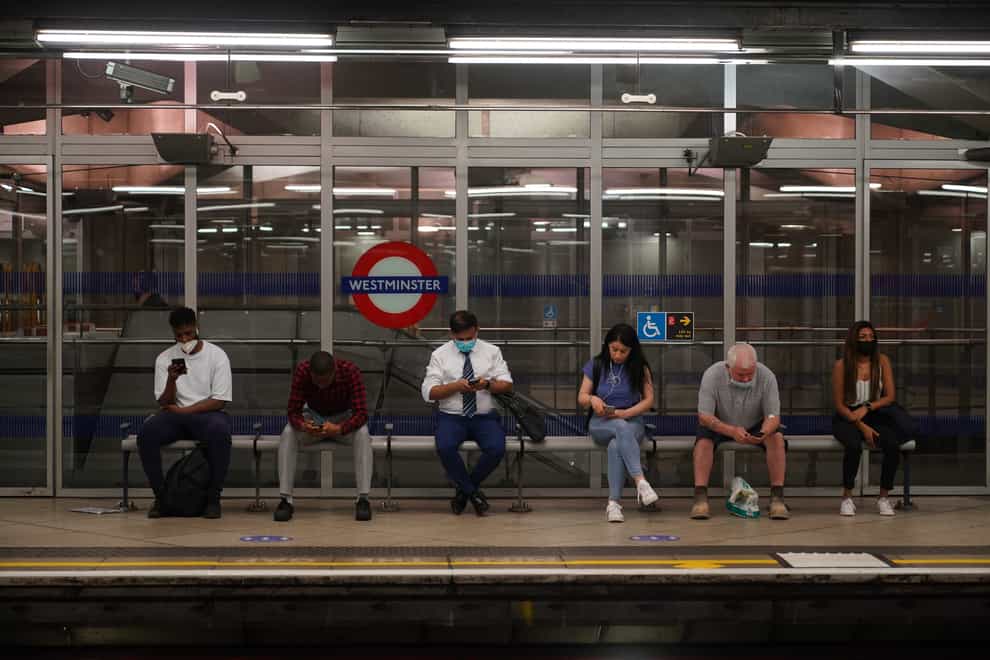 Commuters at Westminster Underground station (PA)
