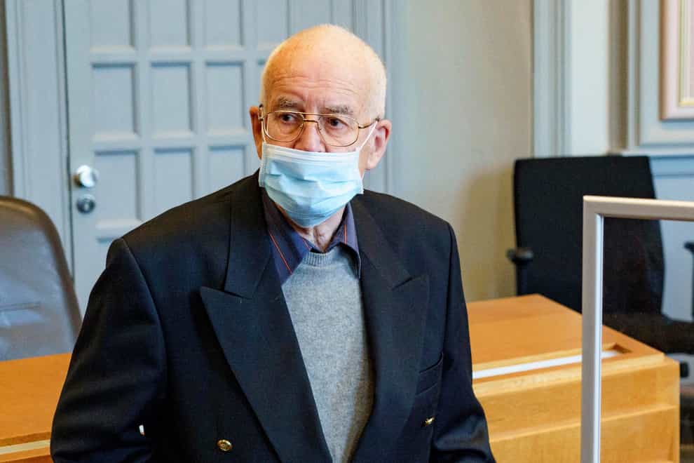 FILE – In this May 28, 2021 file photo a 84-year-old, accused of possession of a tank, waits in the courtroom for the start of the trial in Kiel, Germany. A German court has convicted a 84-year-old man for illegal weapons possession of a Panther tank, a flak canon and multiple other World War II-era military weapons to a suspended prison sentence of one year and two months. (Axel Heimken/dpa via AP)