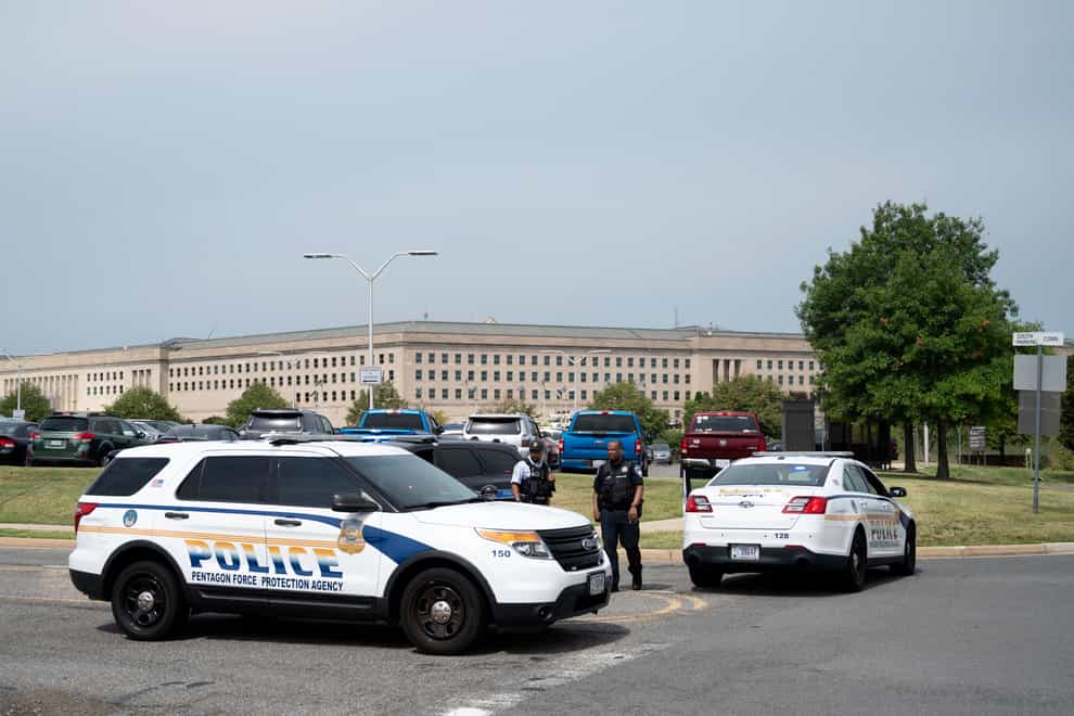 Police block off an entrance to the Pentagon following reports of multiple gun shots fired on a bus platform near the facility’s Metro station Tuesday, Aug, 3 2021, in Washington. (AP Photo/Kevin Wolf)