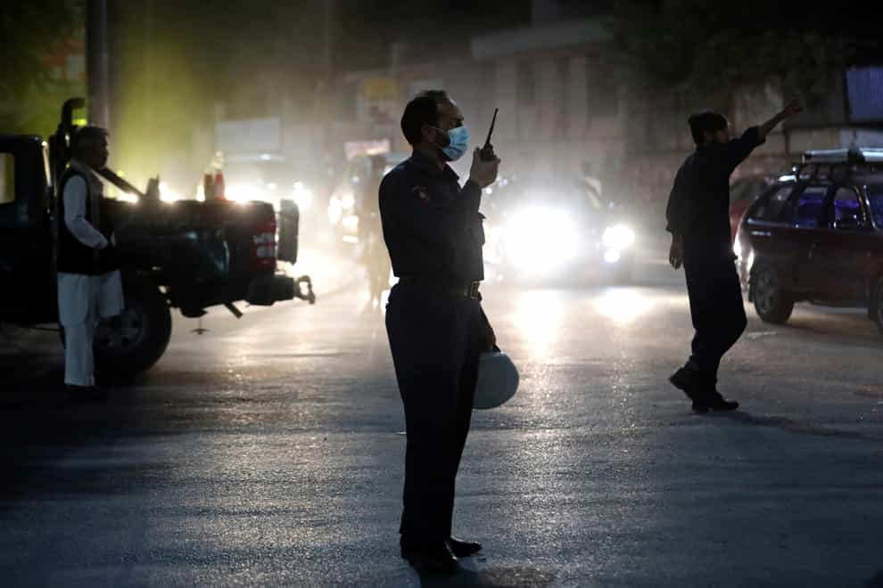 Afghan security personnel work at the site of a powerful explosion in Kabul, Afghanistan, Tuesday, Aug. 3, 2021. The explosion rocked a posh neighborhood of the Afghan capital where several senior government officials live. (AP Photo/Rahmat Gul)