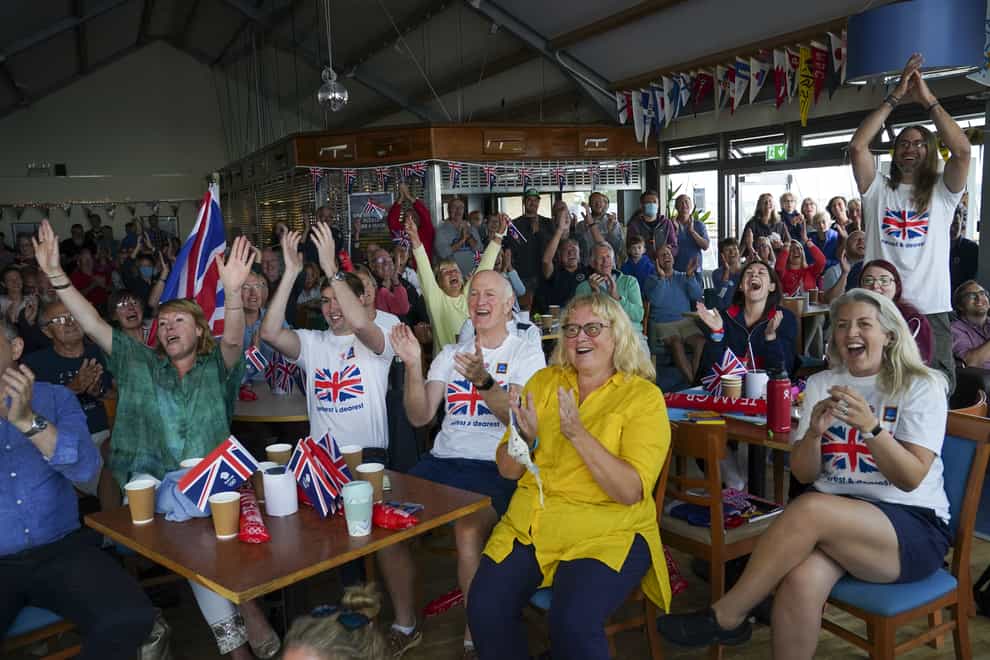 Family and friends of Olympic gold medallist Eilidh McIntyre celebrate at Hayling Island Sailing Club, Hampshire, as her boat crosses the finish line at Tokyo 2020 (Steve Parsons/PA)