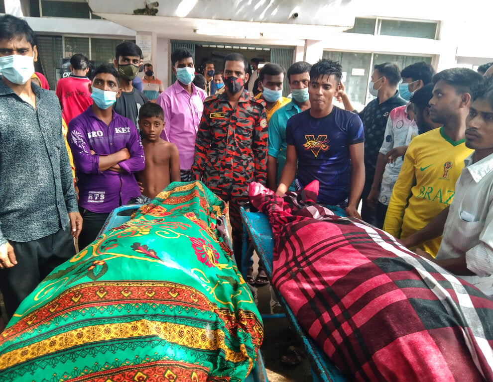 People gather around bodies of victims after lightning killed more than a dozen people in Bangladesh (Md Jahangir Alom/AP)