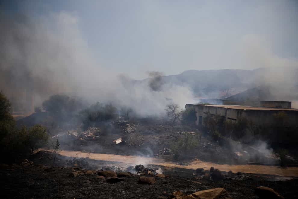 Fields burn following a hit by a rocket fired from Lebanon into Israeli territory, near the northern Israeli town of Kiryat Shmona (AP)