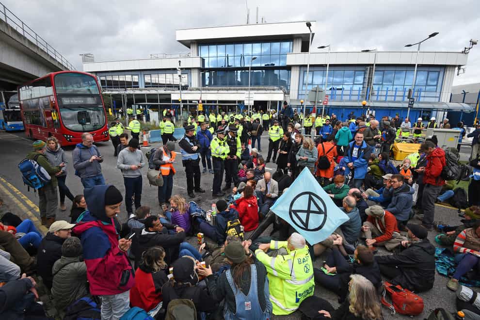 Protesters stage a ‘Hong Kong style’ blockage of the exit from the train station to City Airport, London (PA)