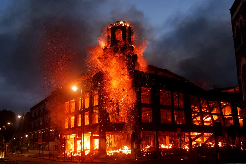 Fire rages through a building in Tottenham, north London during the riots of 2011 (PA)