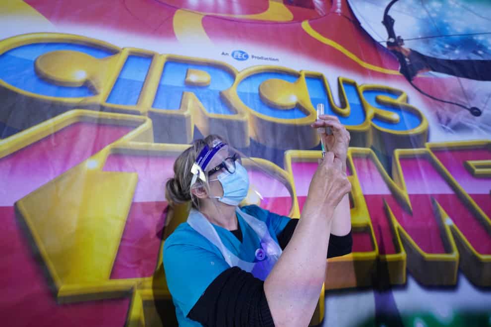 Dr Lisa Pickles, 57, clinical lead for the Calderdale vaccination program prepares a syringe at a pop-up Covid-19 vaccination clinic in the marquee of Circus Extreme in Halifax (Owen Humphreys/PA)