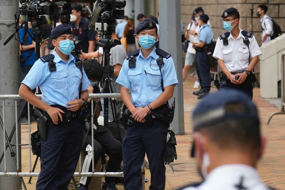 Police officers stand guard outside a court in Hong Kong (Vincent Yu/AP)