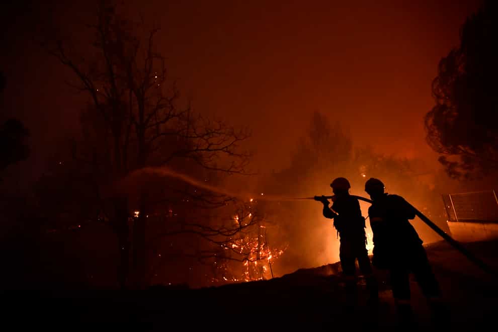 Firefighters try to extinguish a wildfire in Afidnes area, northern Athens, Greece (Michael Varaklas/AP)
