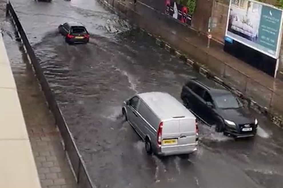 Cars going through flooding on Queenstown Road in Battersea (Iain Beable/PA)