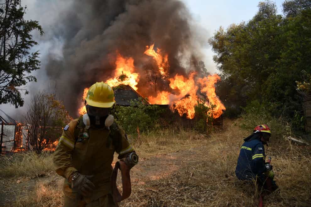 Firefighters operate during a wildfire near Lampiri village (Andreas Alexopoulos/AP)