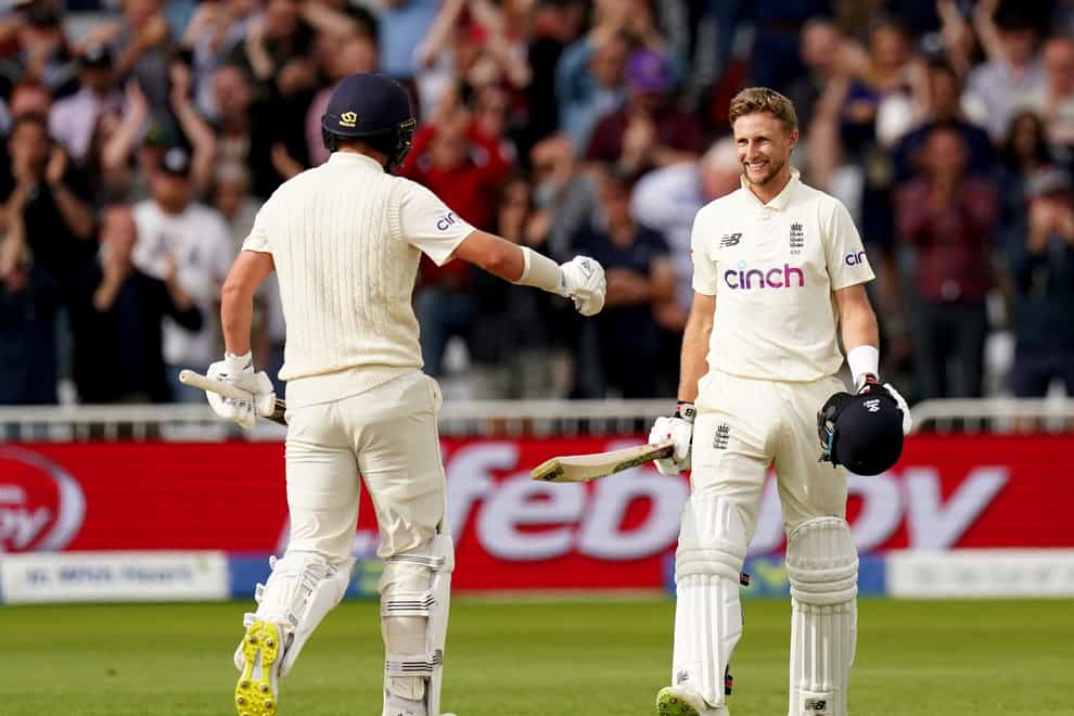 England’s Joe Root, right, celebrates his century with team-mate Sam Curran (Tim Goode/PA)