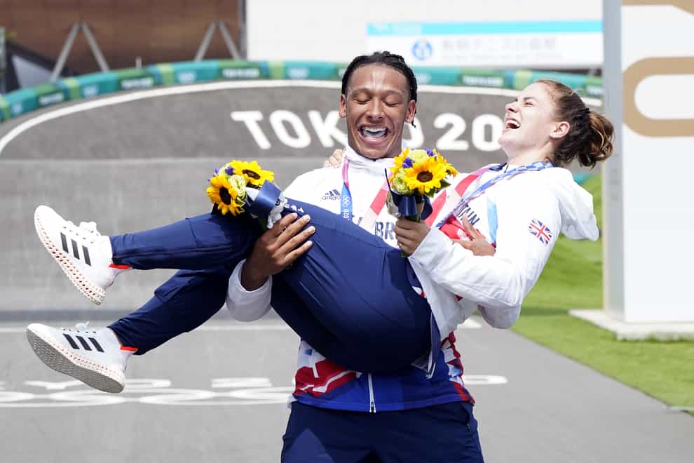 Beth Shriever is held aloft by Kye Whyte after she won BMX racing gold to add to his silver at the Tokyo Olympics (Danny Lawson/PA Images).