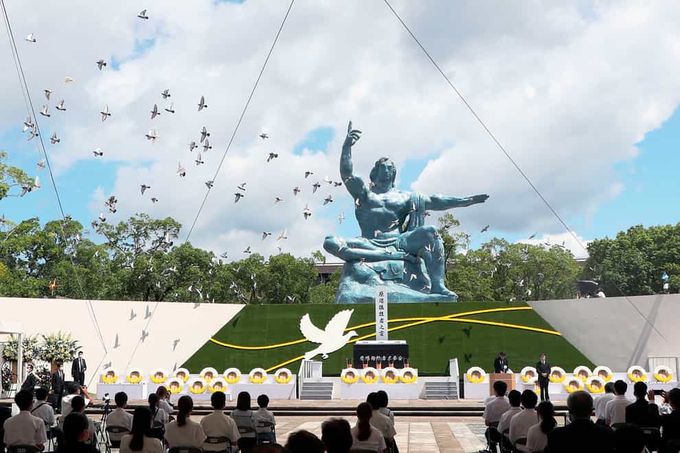 Doves fly over the Statue of Peace during a ceremony at Nagasaki Peace Park in Nagasaki (Kyodo News via AP)
