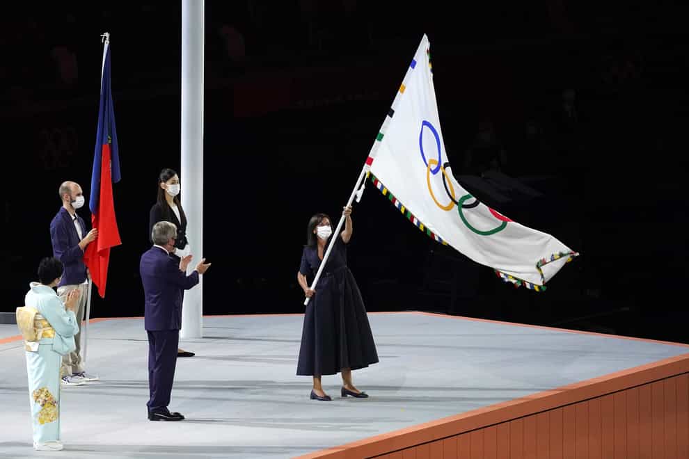 The Olympic flag is handed over by IOC president Thomas Bach to Paris mayor Anne Hidalgo during the closing ceremony of Tokyo 2020 (Martin Rickett/PA Images).