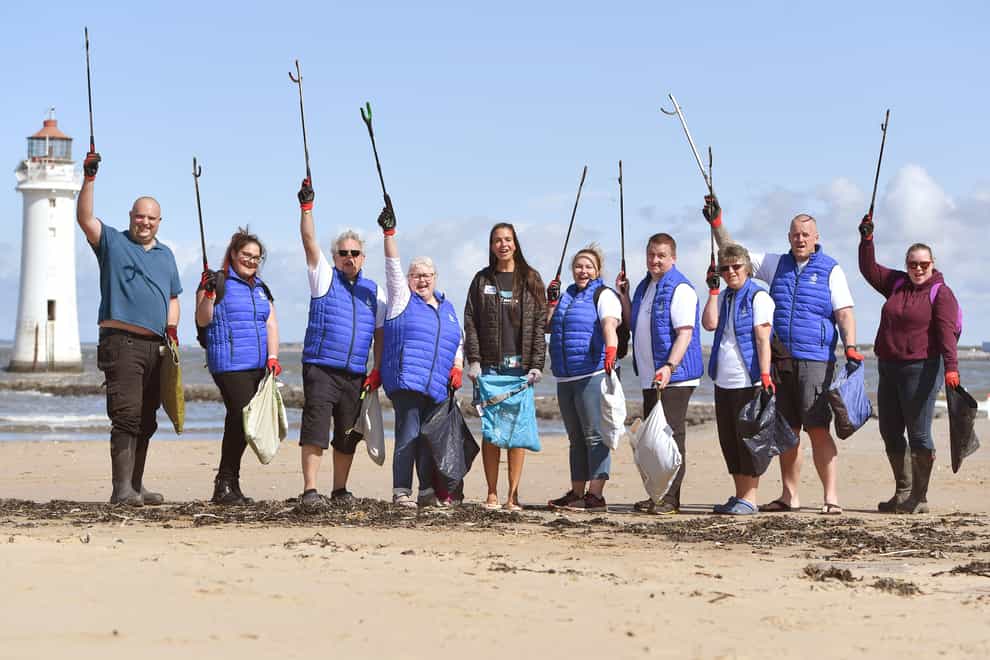 Undated handout photo issued by Camelot of National Lottery winners helping clean up New Brighton Beach during the 2 Minute Beach Clean charity initiative. A team of multi-millionaire lottery winners have spent a morning clearing plastic from a beach. Issue date: Monday August 9, 2021.