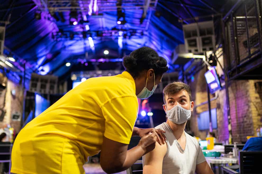 Nathaniel McVeigh receives a dose the Pfizer/BioNTech Covid-19 vaccine at Heaven nightclub in central London (Dominic Lipinski/PA)