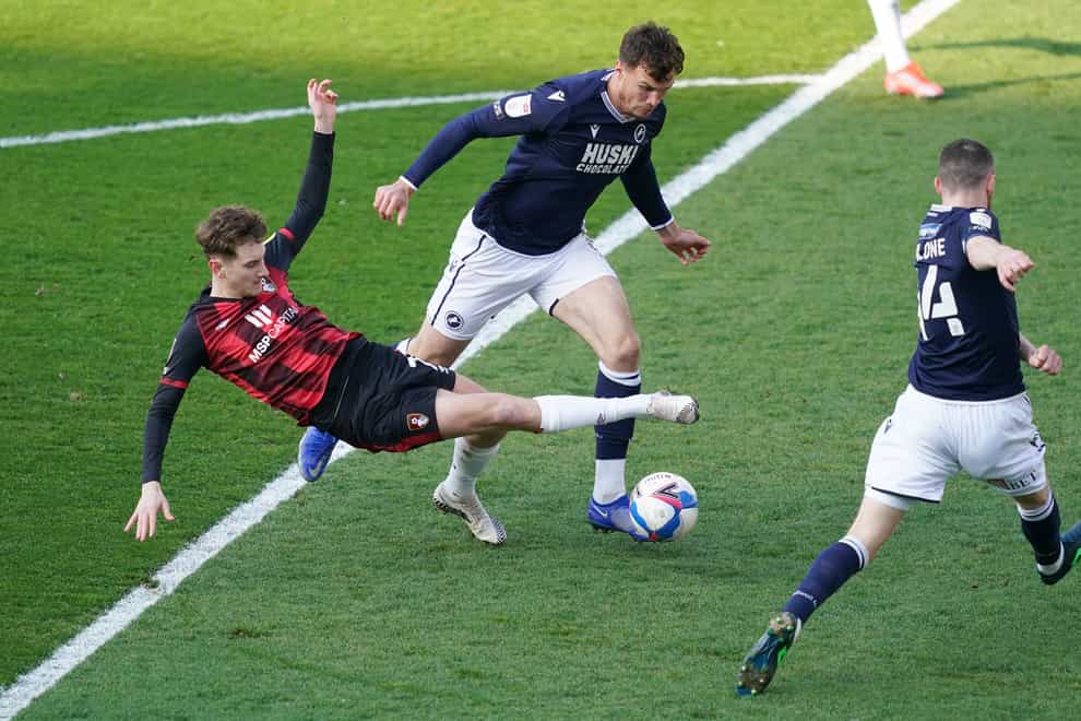 Jake Cooper (with the ball) missed Millwall’s 1-1 draw at QPR due to a back problem (John Walton/PA).