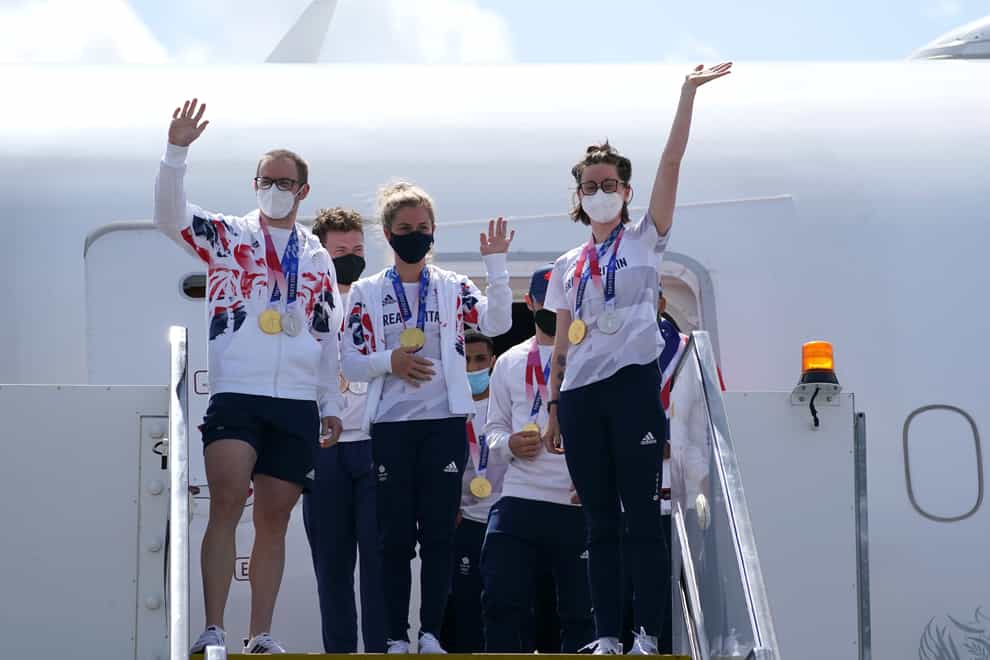 Great Britain’s Jason and Laura Kenny and Katie Archibald wave as they arrive at Heathrow Airport (Steve PArsons/PA)