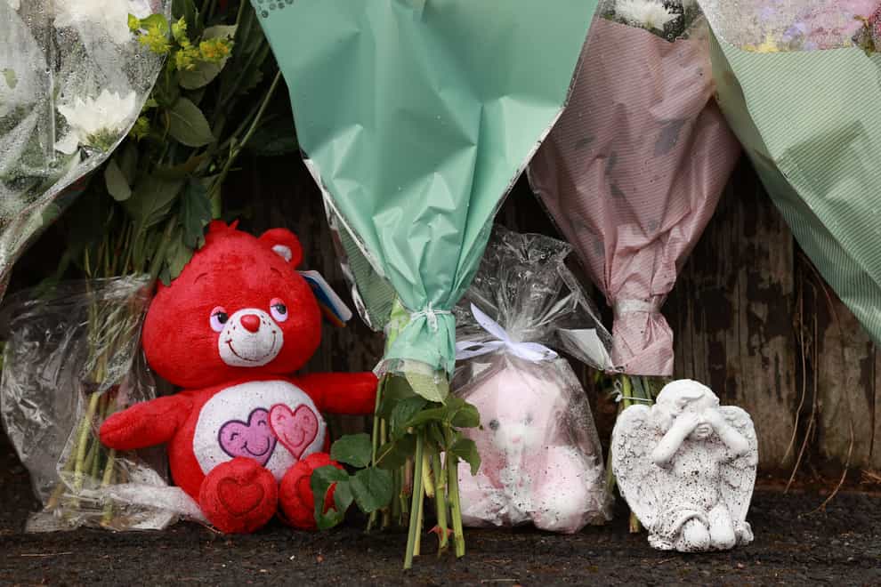 Flowers and soft toys left at the scene in Dungannon, Co Tyrone, where a two-year-old who was found injured on Friday afternoon was rushed to hospital and later died (Liam McBurney/PA)