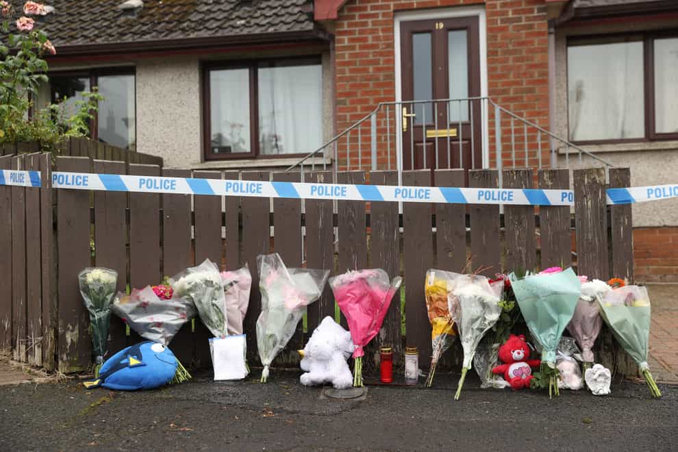 Flowers and soft toys left at the scene in Dungannon, Co Tyrone (PA)