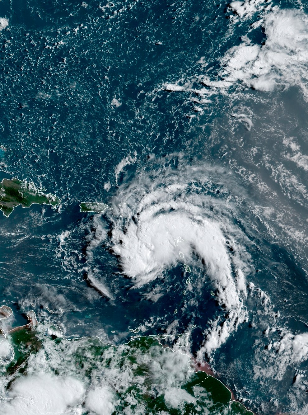 This satellite image provided by the National Oceanic and Atmospheric Administration (NOAA) shows a tropical storm east of Puerto Rico in the Caribbean, at 7:50am EST, Tuesday, Aug. 10, 2021. The National Hurricane Center issued tropical storm warnings for the U.S. Virgin Islands and Puerto Rico, where forecasters expected the potential cyclone to strengthen Tuesday into the sixth named storm, Fred, of the Atlantic hurricane season. (NOAA/NESDIS/STAR GOES via AP)