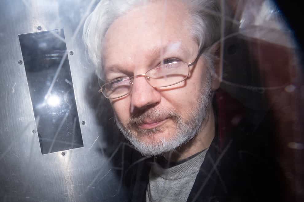 Julian Assange leaving court (PA)