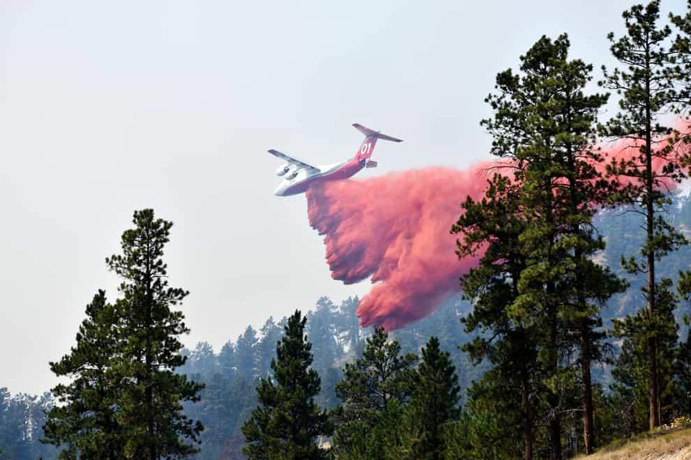 An aircraft drops fire retardant to slow the spread of the Richard Spring fire, east of Lame Deer, Montana (Matthew Brown/AP)