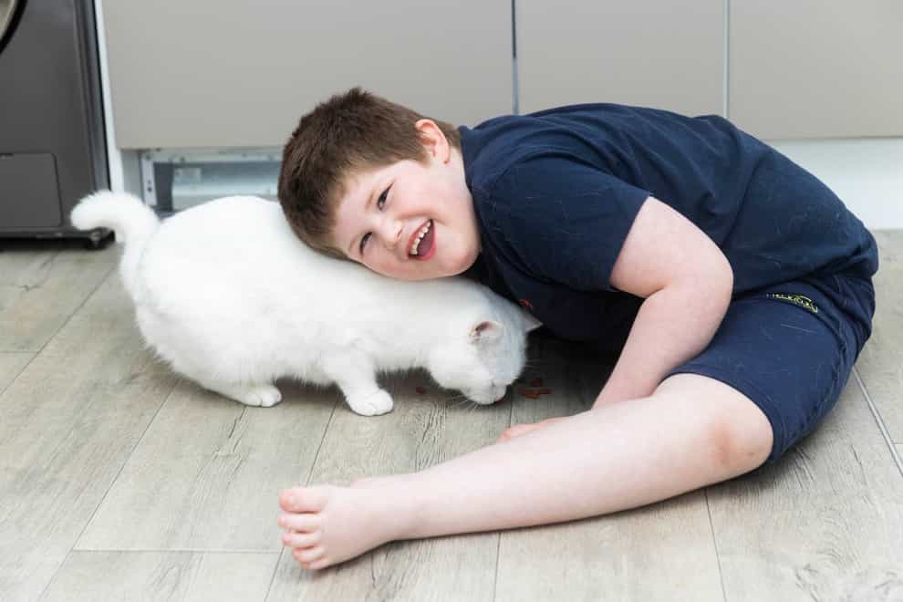 Connor Raven, aged six, and his cat Minty (Fabio De Paola/Cats Protection)