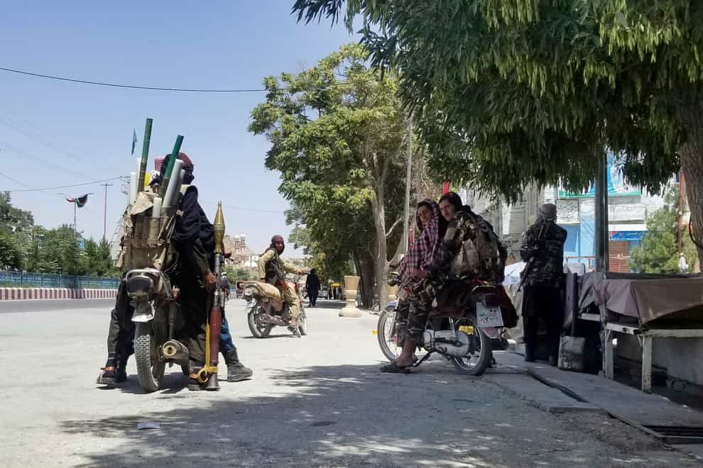 Taliban fighters patrol inside the city of Ghazni, south-west of Kabul Gulabuddin Amiri/AP)
