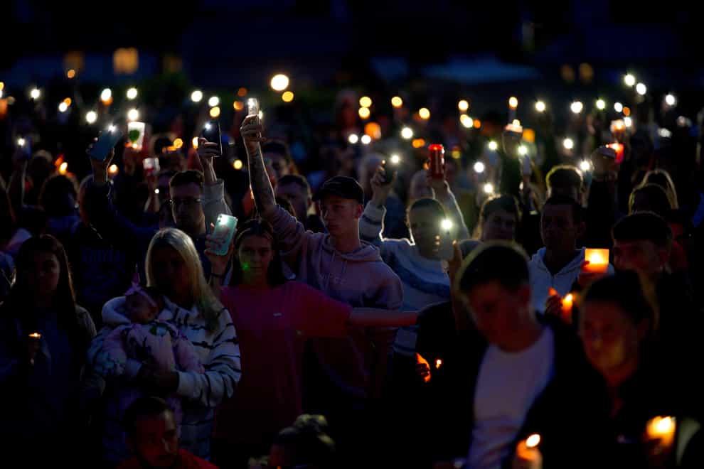 Flowers and candles in North Down Crescent Park on Friday (Ben Birchall/PA)