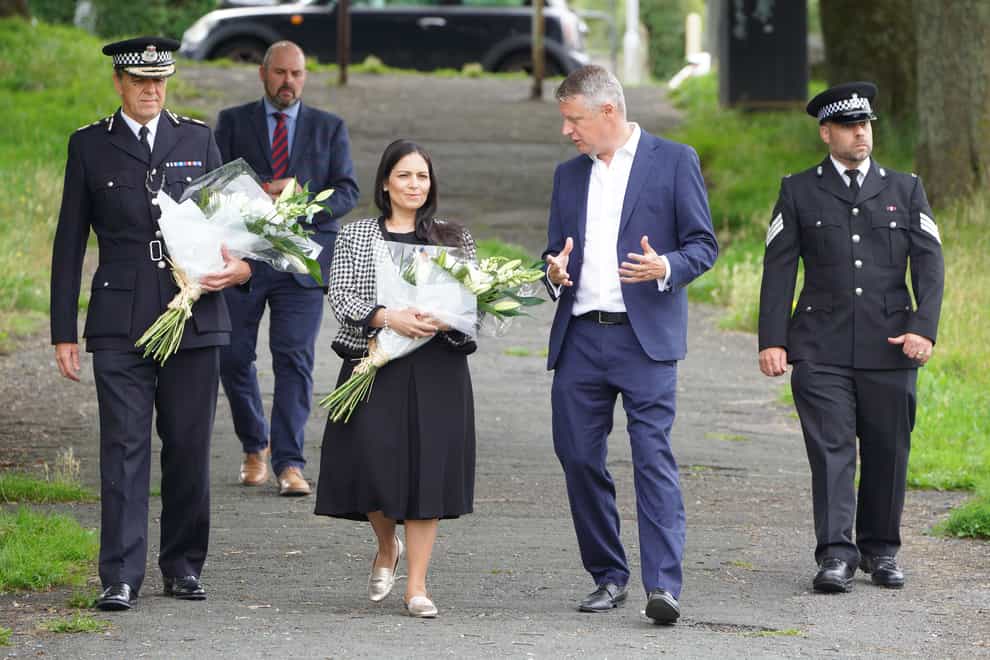 (left to right) Chief Constable of Devon and Cornwall Police, Shaun Sawyer, Home Secretary Priti Patel and Plymouth Sutton and Devonport MP Luke Pollard, bringing flowers to lay with the tributes in Plymouth, Devon, where five people were killed by gunman Jake Davison in a firearms incident on Thursday evening (Ben Birchall/PA)