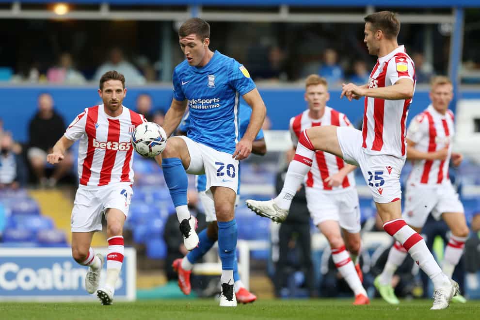 Gary Gardner (centre)and Stoke City’s Nick Powell during the Sky Bet Championship match at St Andrew’s Trillion Trophy Stadium, Birmingham. Picture date: Saturday August 14, 2021.