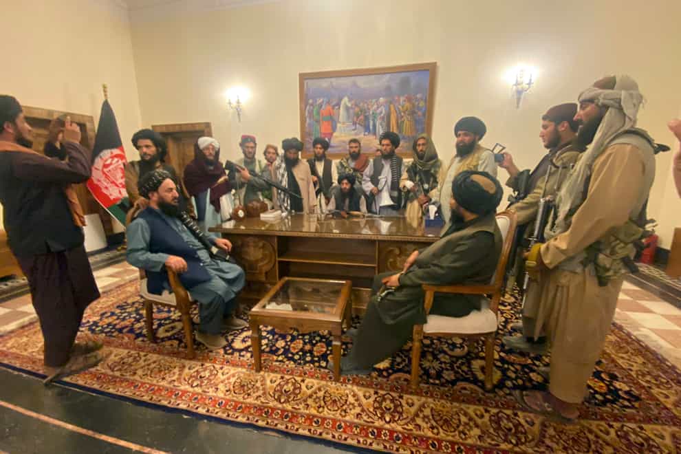 Taliban fighters take control of the Afghan presidential palace in Kabul after President Ashraf Ghani fled the country (Zabi Karimi/AP)