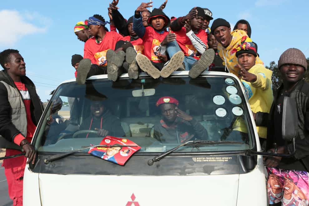 Supporters of Zambian opposition leader Hakainde Hichilema celebrate on the streets of Lusaka, Zambia (Tsvangirayi Mukwazhi/AP)