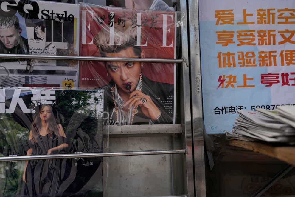 A magazine cover featuring Chinese-Canadian pop star Kris Wu (centre (Ng Han Guan/AP)
