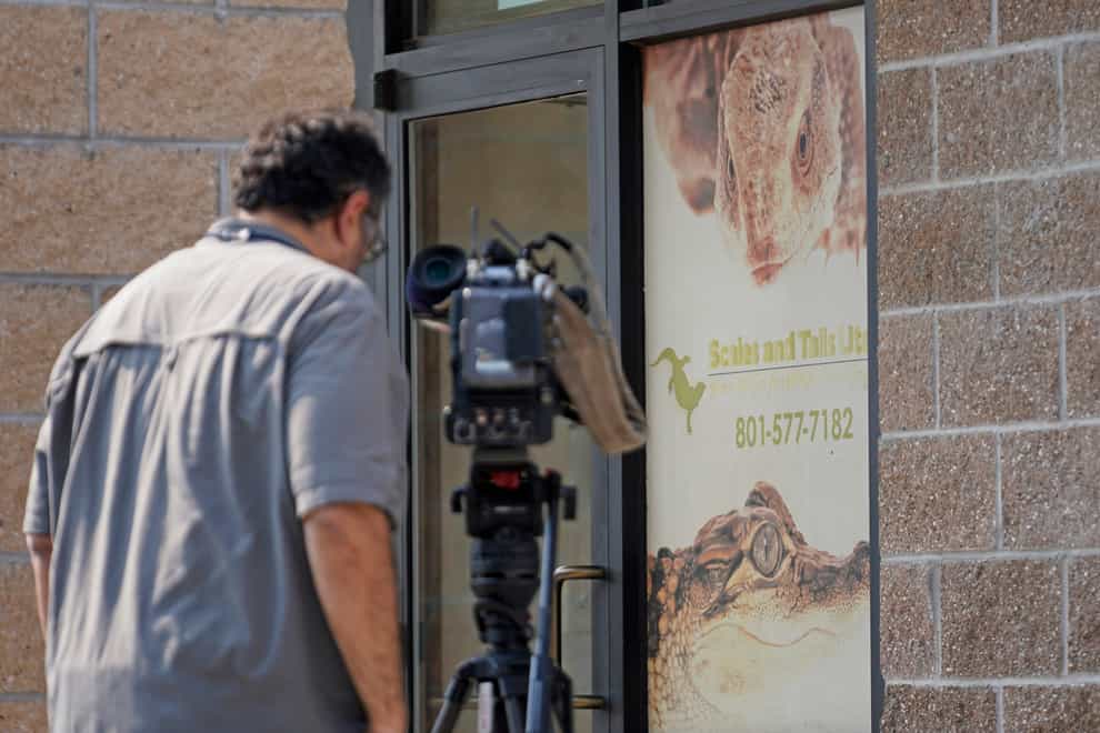 A TV cameraman films the entrance of Scales and Tails Utah (Rick Bowmer/AP)