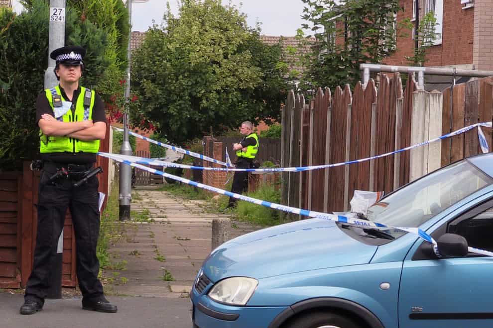 Police officers at the scene in Naburn Fold, in the Whinmoor area of Leeds (PA)