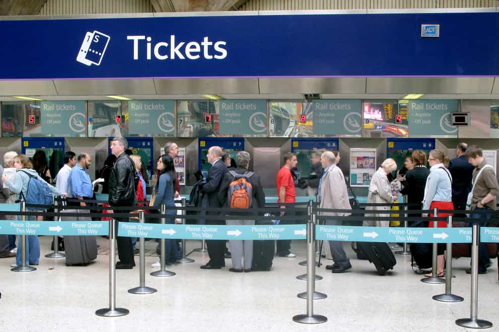 People queuing for train tickets (Katie Collins/PA)