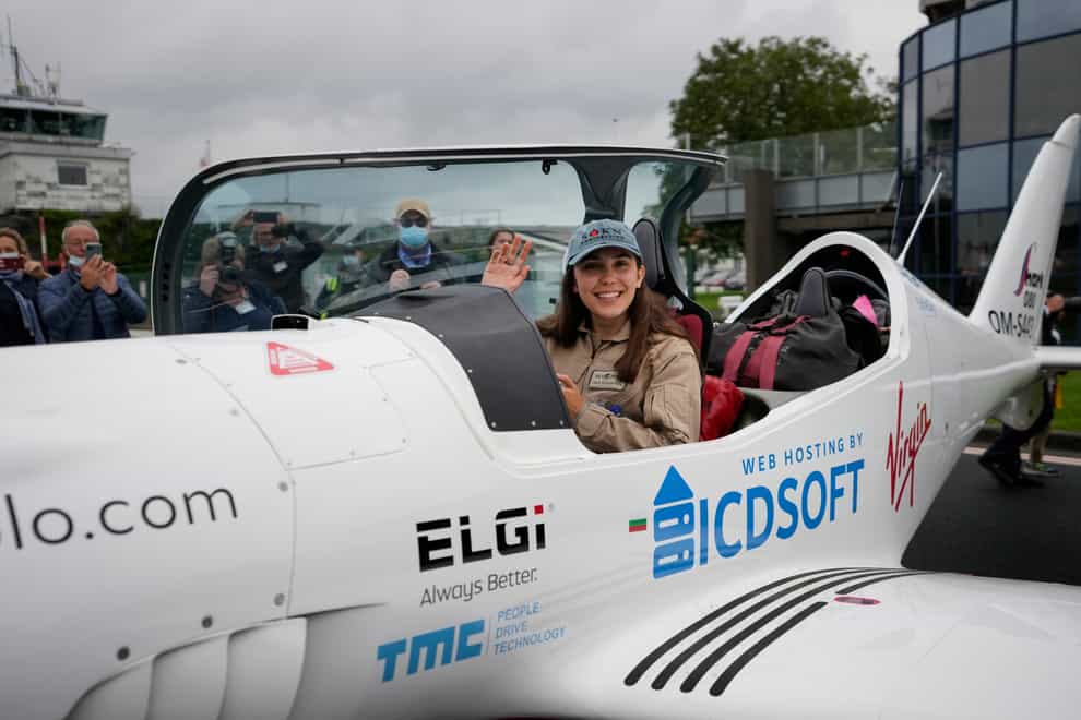 Belgian-British teenager Zara Rutherford waves from her Shark Ultralight plane prior to take-off at the Kortrijk-Wevelgem airfield in Wevelgem, Belgium (Virginia Mayo/AP)