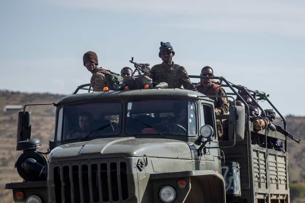Ethiopian government soldiers ride in the back of a lorry on a road near Agula, north of Mekele, in the Tigray region of northern Ethiopia (Ben Curtis/AP)