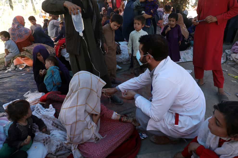 Internally displaced Afghan women from northern provinces, who fled their home due to fighting between the Taliban and Afghan security personnel, receive medical care in a public park in Kabul, Afghanistan (Rahmat Gul/AP)