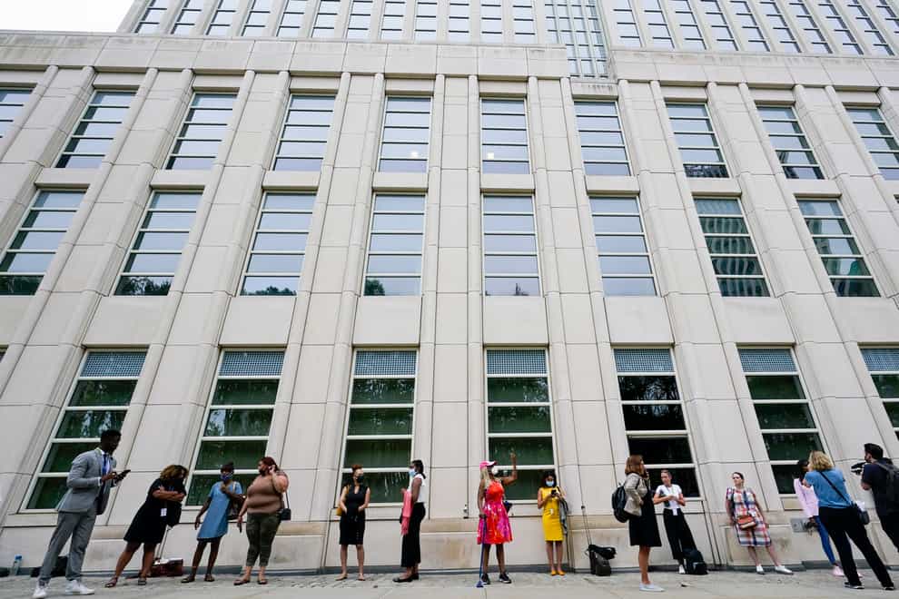 Reporters and spectators wait in line outside Brooklyn Federal court for opening statements in R&B star R Kelly’s long-anticipated federal trial (Mary Altaffer/AP)