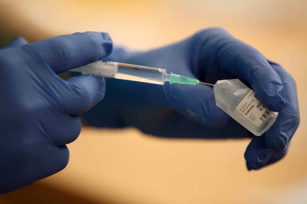 A nurse prepares the BioNTech/Pfizer Covid-19 vaccine for doctors to inject into elderly residents arms (Nick Potts/PA)