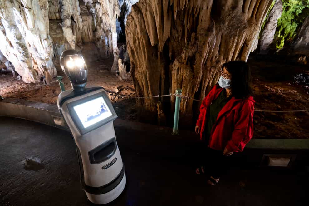 A guide programs Persephone inside Alistrati Cave, north-east of Thessaloniki, Greece (Giannis Papanikos/AP)