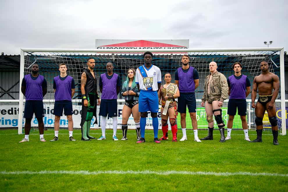 Enfield Town players and WWE NXT UK wrestlers pose following the announcement of their commercial partnership (WWE)