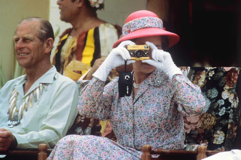 The Queen taking photographs during her visit to the South Sea islands of Tuvalu in 1982 (Ron Bell/PA)